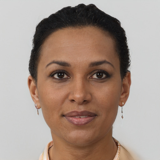 Joyful black adult female with short  brown hair and brown eyes