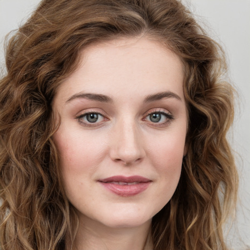 Joyful white young-adult female with long  brown hair and green eyes