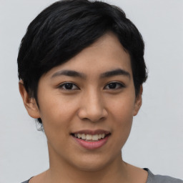 Joyful asian young-adult female with short  black hair and brown eyes