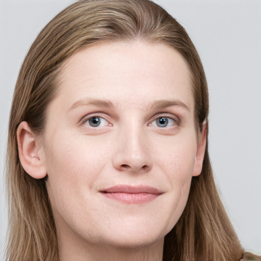 Joyful white young-adult female with long  brown hair and blue eyes