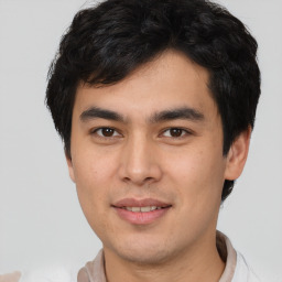 Joyful asian young-adult male with short  brown hair and brown eyes