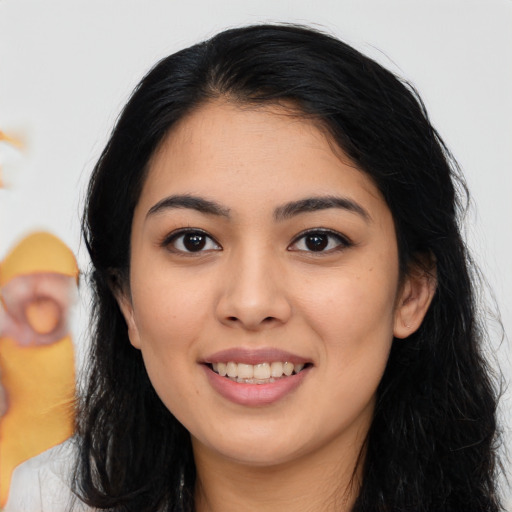 Joyful asian young-adult female with long  black hair and brown eyes