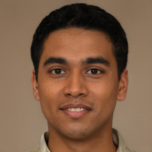 Joyful latino young-adult male with short  black hair and brown eyes