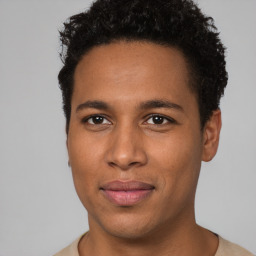 Joyful black young-adult male with short  brown hair and brown eyes