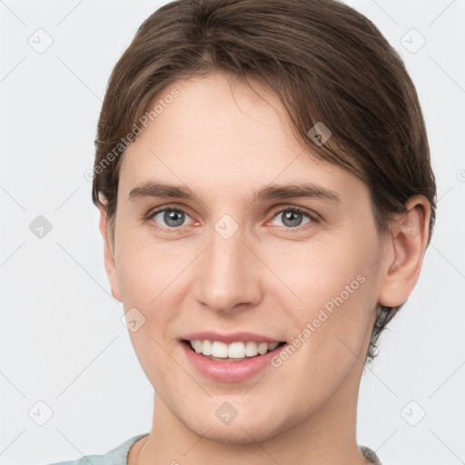 Joyful white young-adult female with short  brown hair and grey eyes