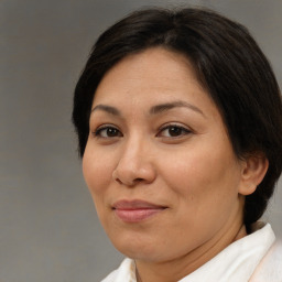 Joyful white adult female with short  brown hair and brown eyes