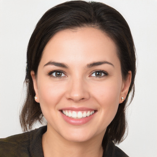 Joyful white young-adult female with long  brown hair and brown eyes