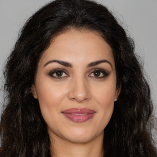 Joyful latino young-adult female with long  brown hair and brown eyes