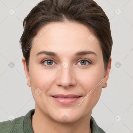 Joyful white young-adult female with short  brown hair and grey eyes