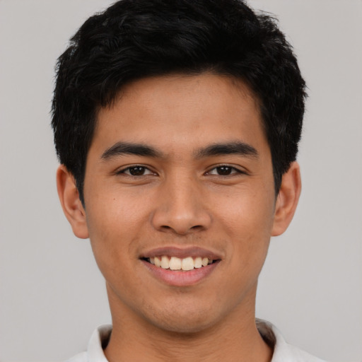 Joyful asian young-adult male with short  black hair and brown eyes
