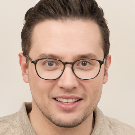 Joyful white young-adult male with short  brown hair and grey eyes