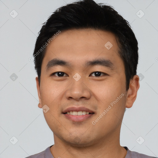 Joyful asian young-adult male with short  black hair and brown eyes