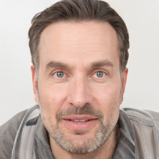 Joyful white adult male with short  brown hair and grey eyes