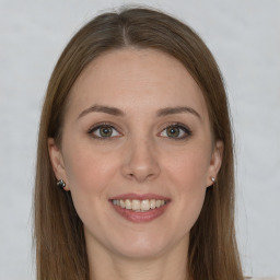 Joyful white young-adult female with long  brown hair and green eyes