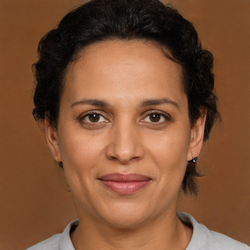 Joyful latino adult female with short  brown hair and brown eyes