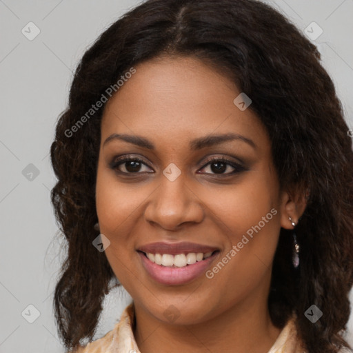 Joyful black young-adult female with long  brown hair and brown eyes