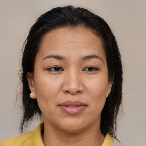 Joyful latino adult female with medium  brown hair and brown eyes