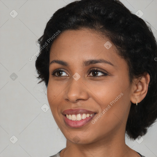 Joyful black young-adult female with medium  black hair and brown eyes