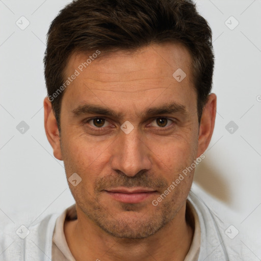 Joyful white adult male with short  brown hair and brown eyes