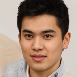 Joyful latino young-adult male with short  brown hair and brown eyes