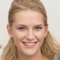 Joyful white young-adult female with long  brown hair and blue eyes