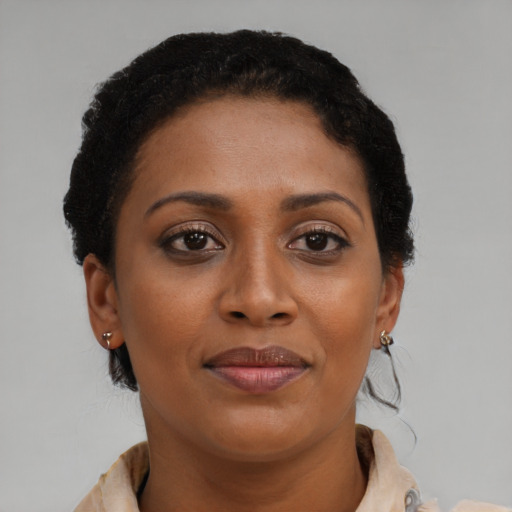 Joyful black young-adult female with short  brown hair and brown eyes