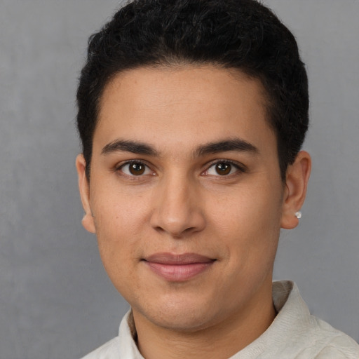 Joyful latino young-adult male with short  brown hair and brown eyes