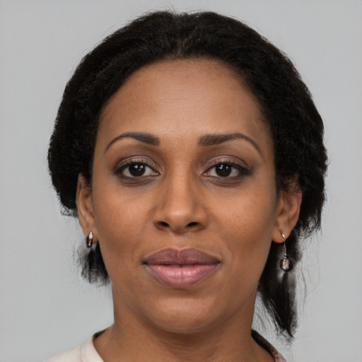 Joyful black adult female with medium  black hair and brown eyes