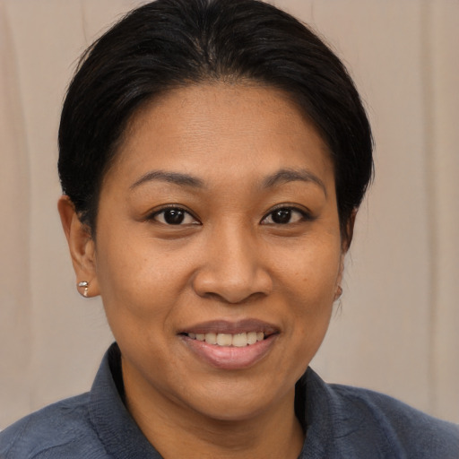 Joyful asian young-adult female with medium  black hair and brown eyes