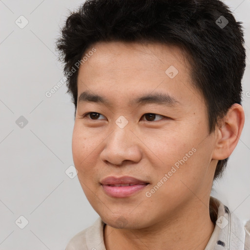 Joyful asian young-adult male with short  brown hair and brown eyes