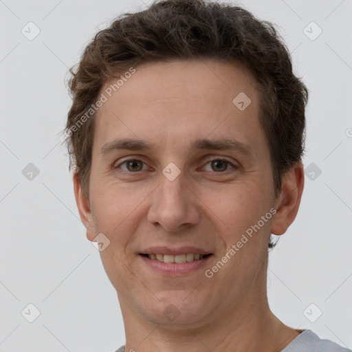 Joyful white adult male with short  brown hair and grey eyes