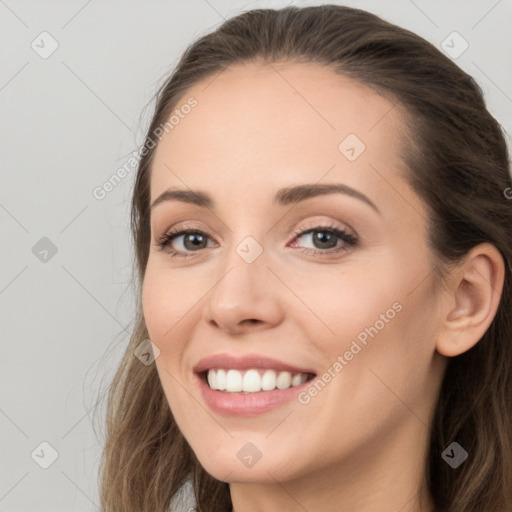 Joyful white young-adult female with long  brown hair and brown eyes