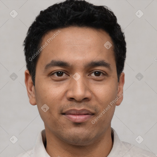 Joyful latino young-adult male with short  black hair and brown eyes