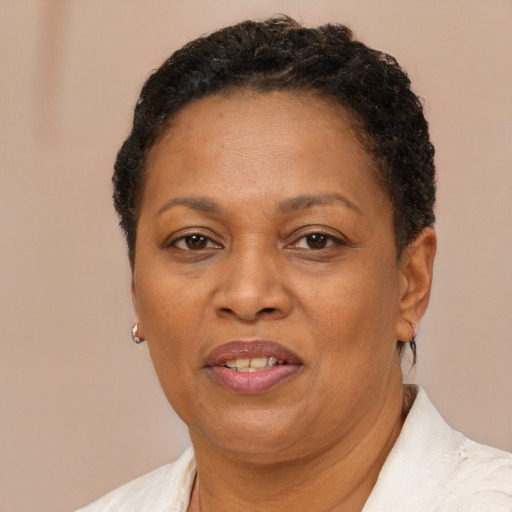 Joyful black adult female with short  brown hair and brown eyes