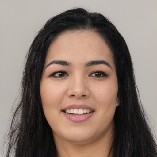 Joyful asian young-adult female with long  black hair and brown eyes