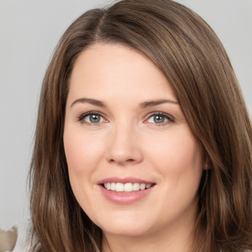 Joyful white young-adult female with long  brown hair and brown eyes