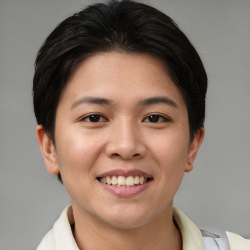 Joyful asian young-adult female with short  brown hair and brown eyes