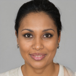 Joyful black young-adult female with medium  brown hair and brown eyes