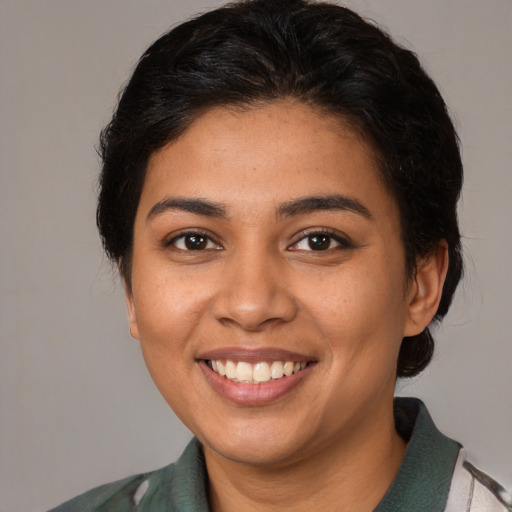 Joyful latino young-adult female with medium  brown hair and brown eyes
