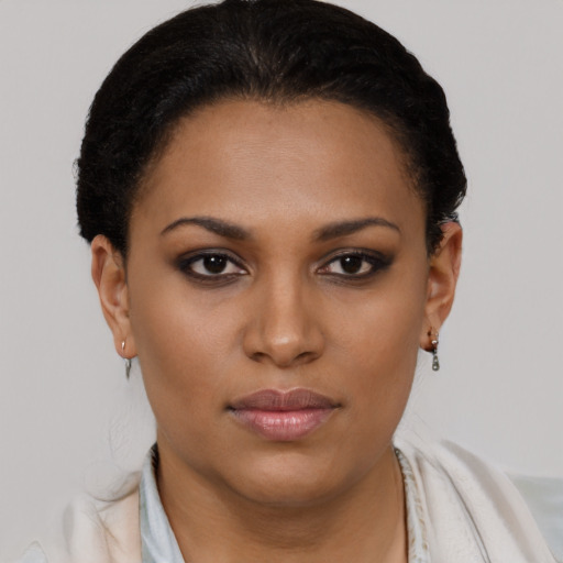 Joyful black young-adult female with short  brown hair and brown eyes