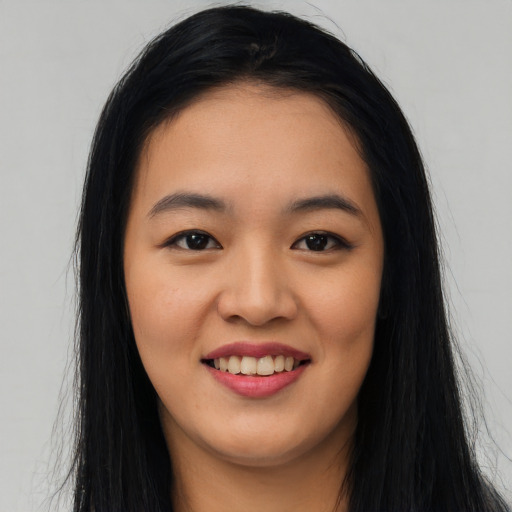 Joyful asian young-adult female with long  black hair and brown eyes