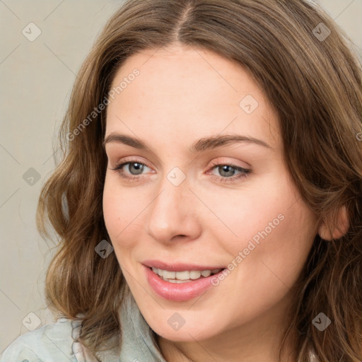 Joyful white young-adult female with medium  brown hair and green eyes