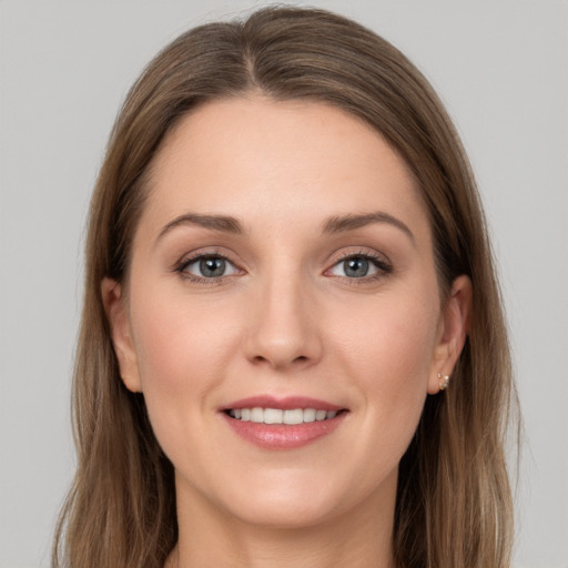 Joyful white young-adult female with long  brown hair and grey eyes