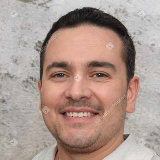 Joyful white young-adult male with short  black hair and brown eyes