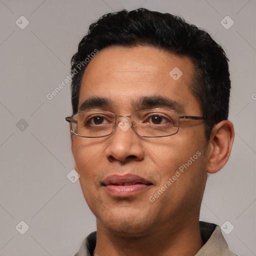 Joyful white adult male with short  black hair and brown eyes