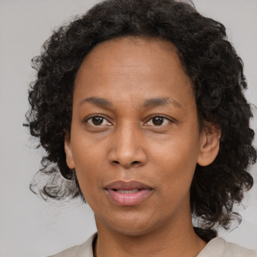 Neutral black adult female with medium  black hair and brown eyes