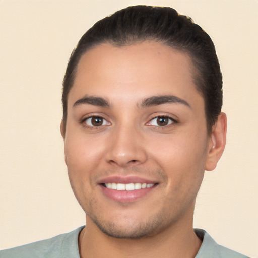 Joyful white young-adult male with short  black hair and brown eyes