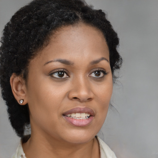 Joyful black young-adult female with long  brown hair and brown eyes