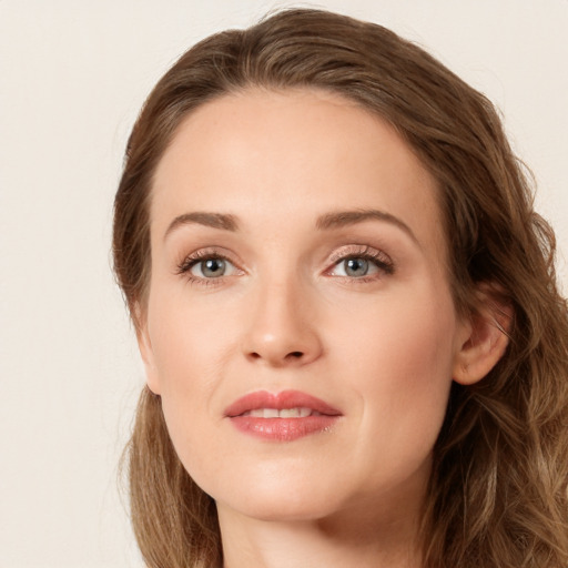 Joyful white young-adult female with long  brown hair and green eyes