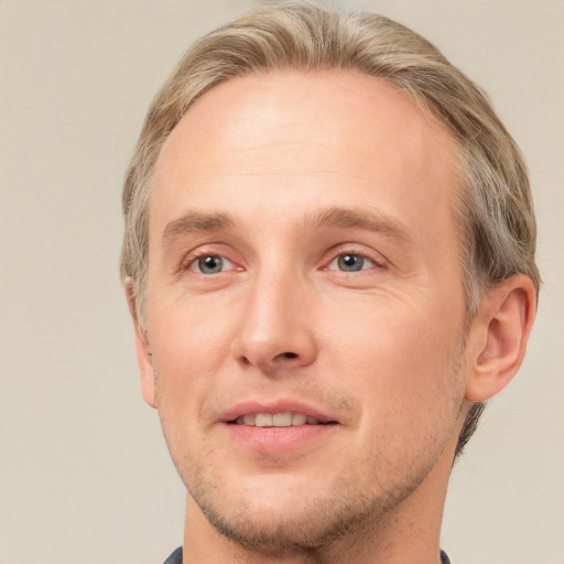 Joyful white adult male with short  brown hair and grey eyes